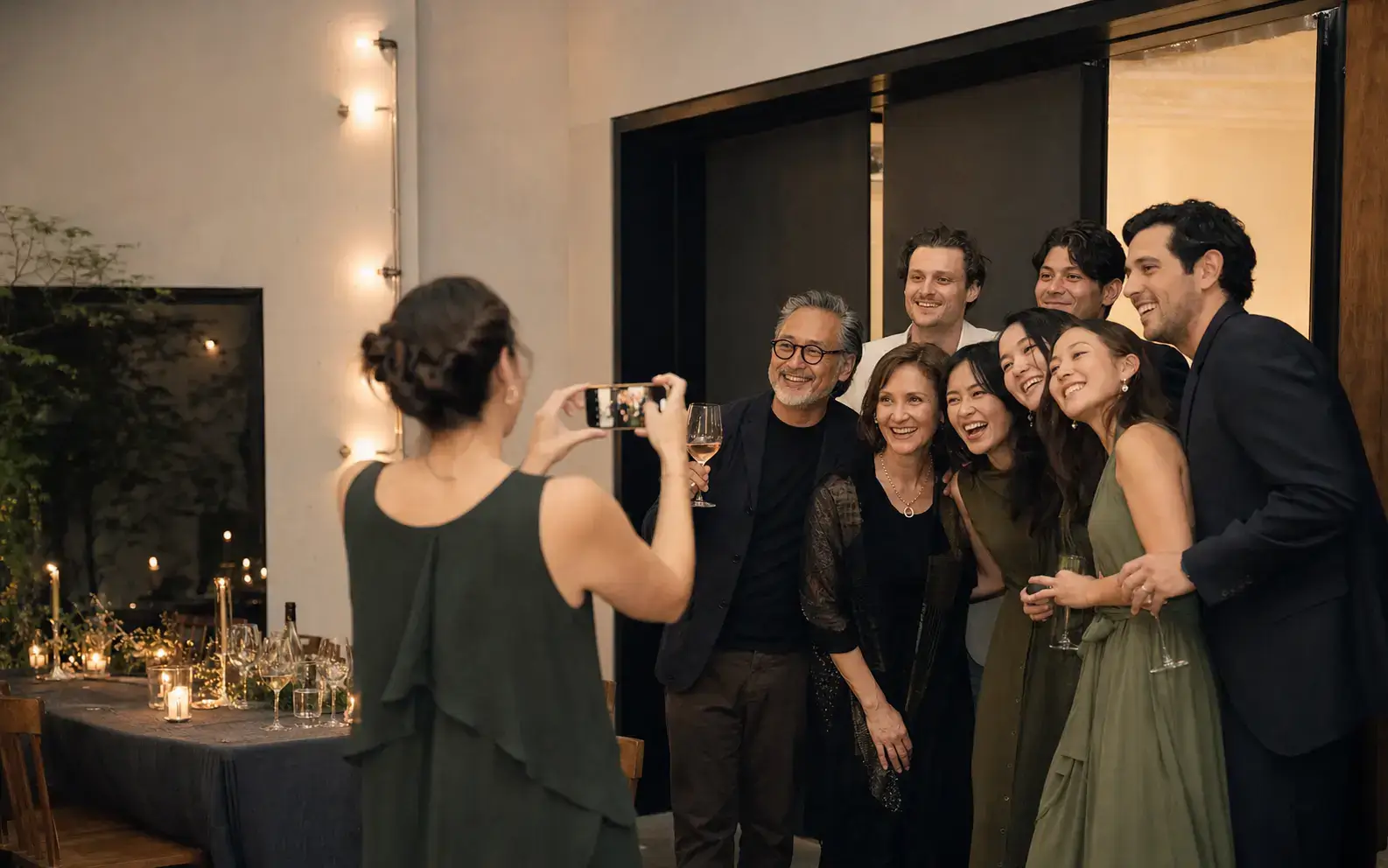 Guests taking a group photo at an evening event